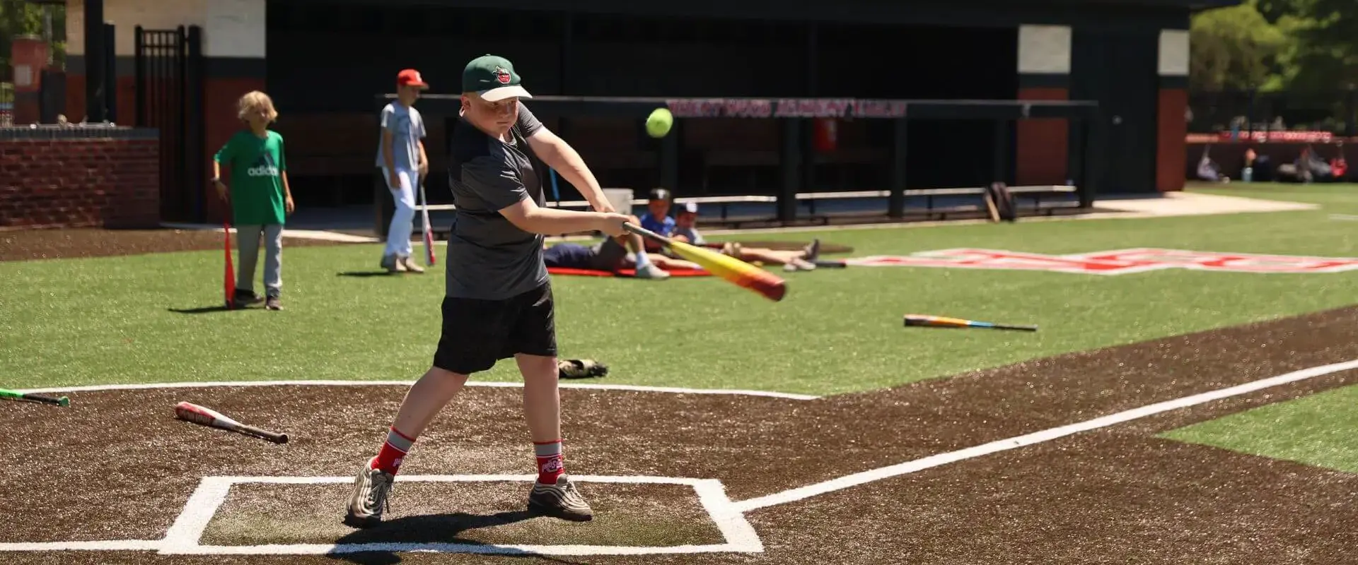 Children playing softball at a BA camp