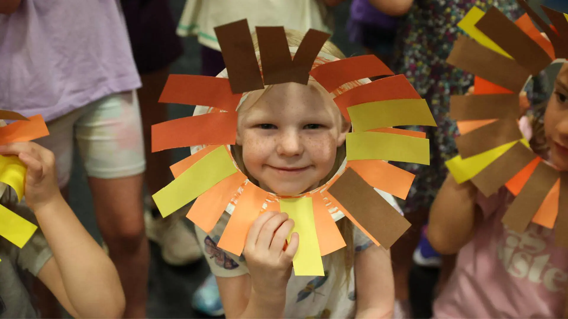 Child wearing a paper-crafted lion's mane