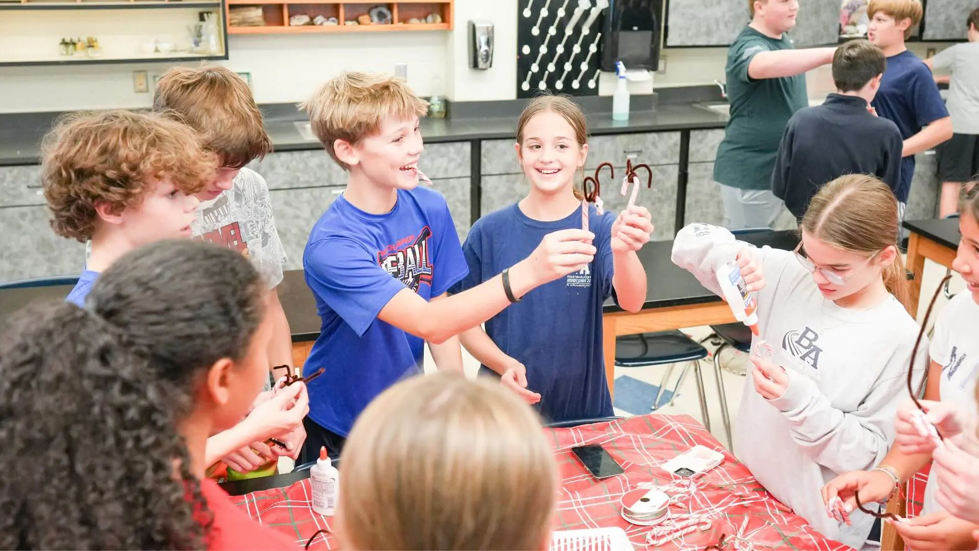 Children creating Christmas crafts with candy canes